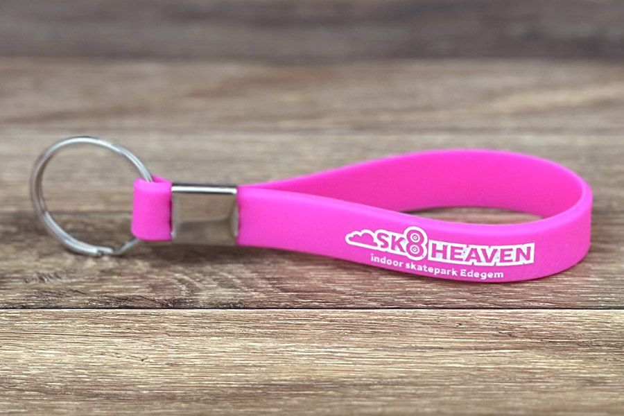 roze siliconen sleutelhanger voor sk8heaven met reliëfdruk die opgevuld werd met witte inkt